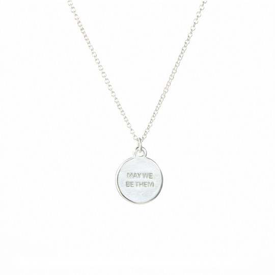 Up close picture of silver necklace that supports charity