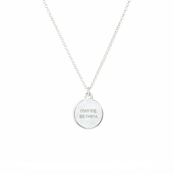 Up close picture of silver necklace that supports charity